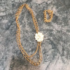 Gold double loop Stella & Dot necklace with flower broach along with bracelet.